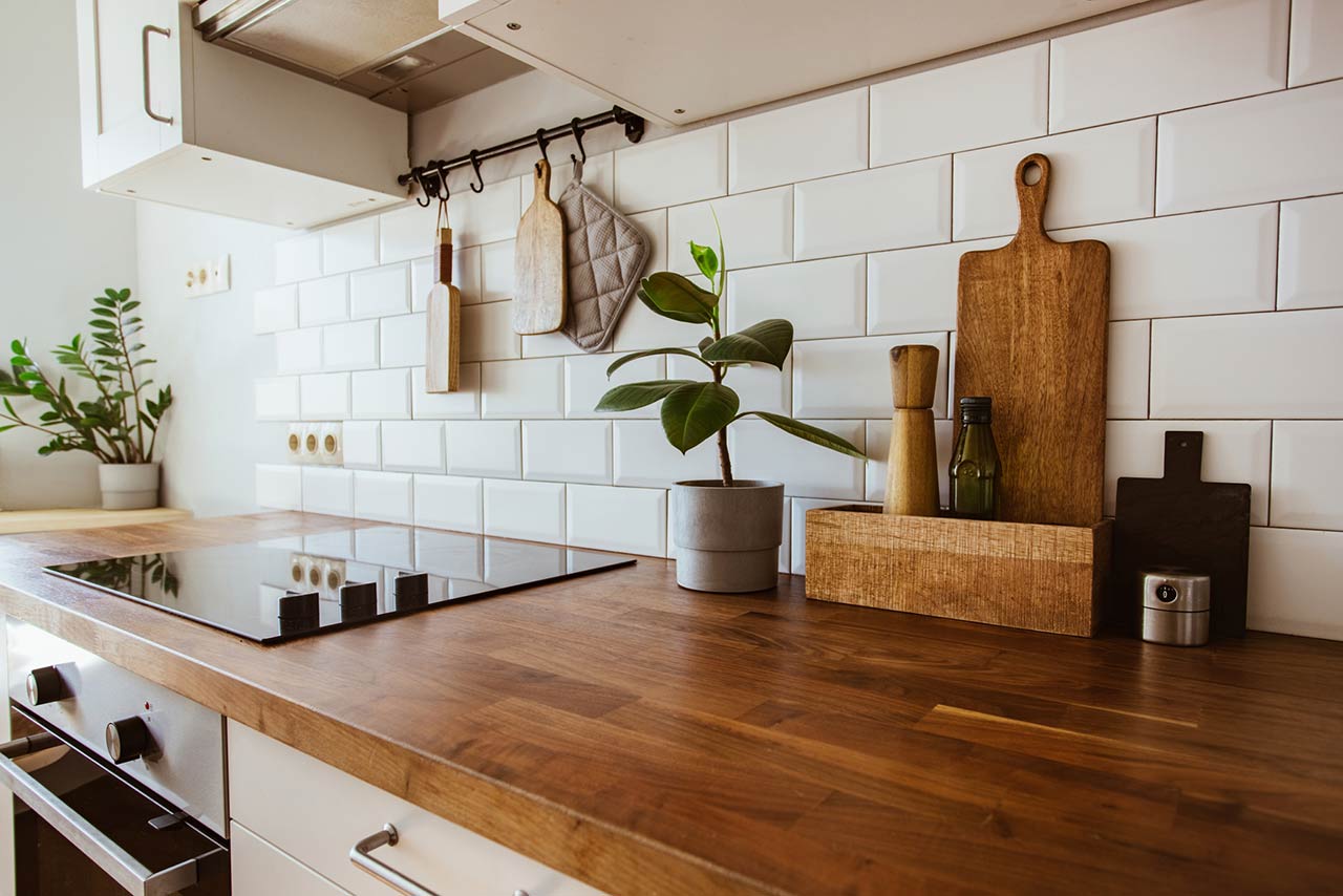 Wooden kitchen counter with cooking accessories and stovetop