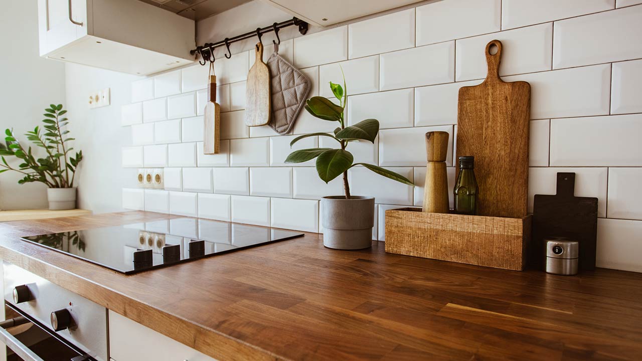 Wooden kitchen counter with cooking accessories and stovetop