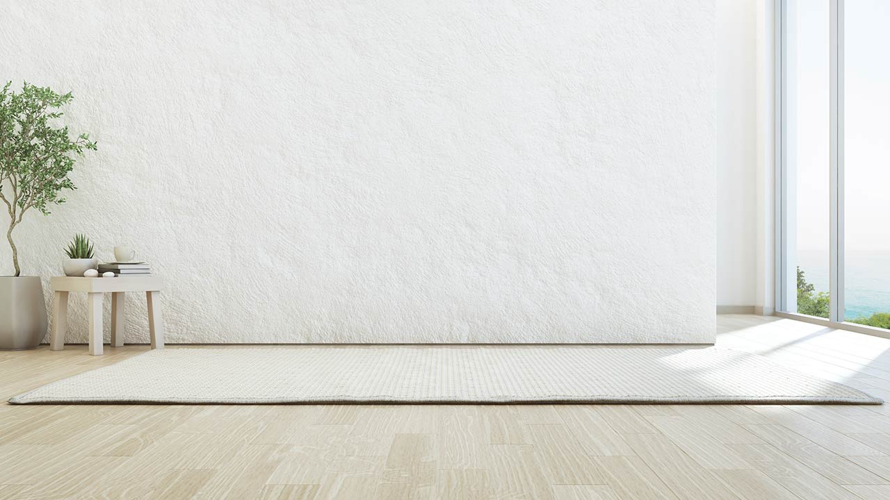 Image of a living area with a side table, rug, and no sofa