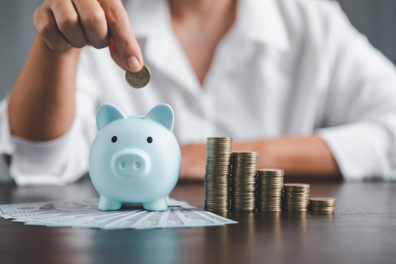 Saving investment banking finance concept. Stack of coins with piggy bank on the table