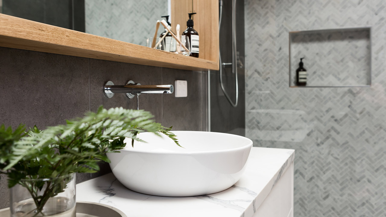 Bathroom details clean white basin with shower tiling behind stock photo