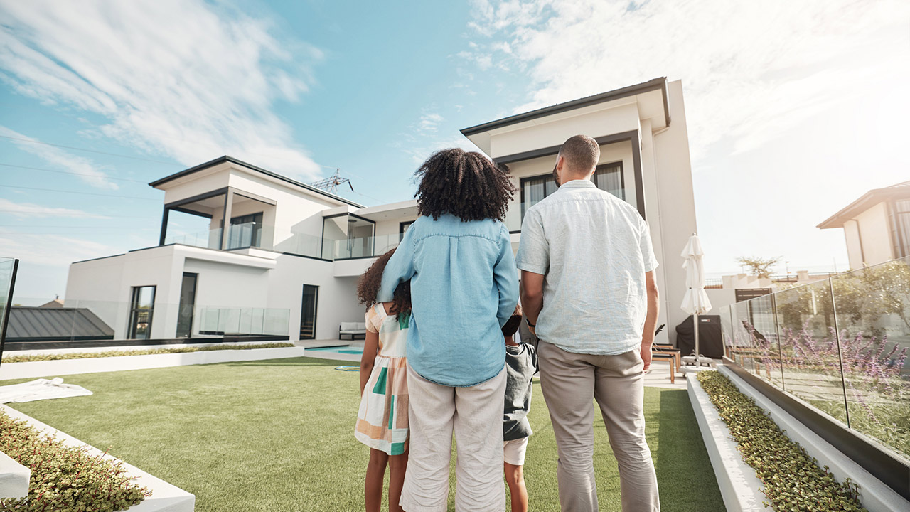 new house and family in their backyard together looking at their property